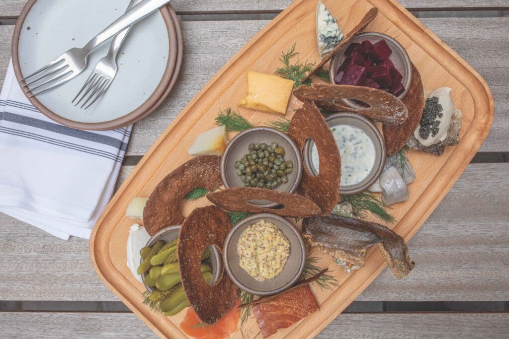 The Stock Board, featuring a selection of house smoked pickled and cured fish and cheeses with accoutrements.