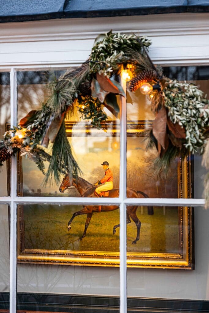 Peering through a window decorated for Christmas